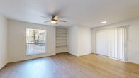 Located at 8330 N 19th Ave in Phoenix, AZ, this single-floor, 2-bedroom, 2-bathroom residence offers a clean and functional layout with a bright, neutral aesthetic throughout. Light wood-style flooring runs consistently across the living areas and bedrooms, creating a cohesive and airy feel. The living room is a comfortable gathering space featuring a ceiling fan, recessed lighting, built-in wall shelving, and vertical blinds on windows that bring in natural light and offer views of the surrounding greenery. Each bedroom is well-proportioned, with the primary bedroom offering ample space, a ceiling fan, and closet access. The second bedroom mirrors this simplicity with its own ceiling fan and closet. Both bathrooms are finished with granite-style countertops and undermount sinks; one bathroom features a shower-tub combo with clean white surrounds. The galley-style kitchen is efficiently designed with stone countertops, white cabinetry, stainless steel appliances including a refrigerator, electric range, and microwave, and a deep utility sink. A hallway connects the main rooms, keeping the layout organized and easy to navigate. The overall ambiance is clean, modern, and move-in ready.