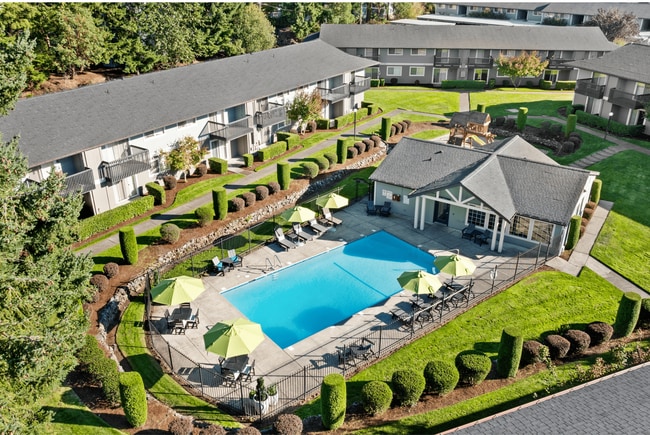 Aerial view of the community featuring a sparkling pool and beautifully landscaped grounds. - Trellis on Orchard Apartments