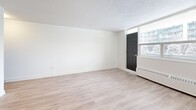 Located at 120 Dundas St E in Mississauga, this well-appointed unit offers three bedrooms, two bathrooms, a living room, dining room, kitchen, and a balcony — all on a single floor. Throughout the unit, light-toned hardwood flooring creates a clean, cohesive aesthetic that complements the crisp white walls and bright, open feel of each room.

The living and dining areas are generously proportioned, with large windows that invite natural light and offer views of the surrounding neighbourhood. The living area features a textured ceiling and baseboard heating, providing practical comfort. An open passageway connects the living and dining spaces to the kitchen, which is visible in warm-toned cabinetry.

Each of the three bedrooms is well-lit, featuring large windows with baseboard heating beneath. The primary bedroom includes mirrored sliding closet doors, enhancing the sense of space. The additional bedrooms are bright and versatile, with clean white walls and the same hardwood flooring. Distinctive dark panel doors add a modern contrast throughout the unit.

The bathrooms are finished with classic white subway tile, a mirrored medicine cabinet, and clean white fixtures, offering a timeless and functional design. The overall ambiance is bright, neutral, and move-in ready.