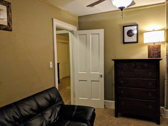 Upstairs north bedroom with chest and click clack futon. - 1044 N Clarkson St