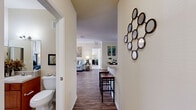 Located at 3000 Marta Cir in Kissimmee, Florida, this well-appointed two-bedroom, two-bathroom single-floor residence offers a thoughtfully designed layout across a comfortable footprint. Rich wood-look flooring flows through the main living areas, complemented by crown molding and neutral warm tones that create a bright, welcoming atmosphere throughout.

The open dining area connects seamlessly to the living room, offering ample space for entertaining. The galley-style kitchen is well-equipped with warm wood cabinetry, light countertops, black appliances including a range, microwave, refrigerator, and dishwasher, plus tile flooring and direct access to the laundry area.

The spacious primary bedroom features plush carpeting, a walk-in closet, and generous natural light from large windows. Its en-suite bathroom is a standout, offering a dual-sink vanity with rich wood cabinetry, tile flooring, and a tub-shower combination. The second bedroom is equally comfortable, with carpeted floors, a bright window with outdoor views, and convenient closet storage. The second bathroom mirrors the quality of the primary, with a single vanity and tub-shower.

A bright nook with oversized windows provides an ideal flex space for a home office. The combination of durable finishes, practical storage, and a functional floor plan makes this Kissimmee residence a versatile and comfortable home.