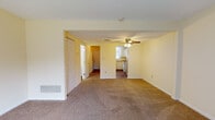 Located at 1530 Koa Dr in Springfield, Ohio, this two-floor residence offers a practical and straightforward layout with consistent finishes throughout. The main living area is generously sized, featuring neutral beige carpeting and soft yellow walls that create a warm, understated atmosphere. A ceiling fan with a light fixture anchors the space, while an open sightline connects directly to the kitchen, enhancing the sense of flow. A sliding glass door admits abundant natural light and provides outdoor access, complemented by vertical blinds for privacy. A closet with bi-fold doors adds convenient storage off the main living space.

The kitchen is efficiently arranged in an L-shaped configuration, featuring white cabinetry, warm-toned laminate countertops, a double stainless steel sink, and a white electric range. A window above the sink brings in natural light, and a dishwasher is included among the appliances.

The bedrooms are carpeted and finished in the same warm neutral palette, each with windows fitted with vertical blinds that allow for natural light and outdoor views. At least one bedroom includes a built-in closet with a hanging rod and shelf for organized storage.

The bathroom features wood-look flooring, a white vanity, and a full tub-shower combination with white tile surround, maintaining a clean and functional aesthetic throughout.