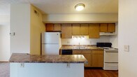 Located at 278 Silver Maple Dr in Delaware, Ohio, this two-story home offers a practical and comfortable layout designed for everyday living. The kitchen is well-equipped with oak cabinetry providing ample storage, dark laminate countertops, a double-basin sink, and a full suite of appliances including a refrigerator, dishwasher, electric range, and over-the-range ventilation. A peninsula counter extends the workspace and adds a natural division between the kitchen and adjacent living areas. Hardwood-style flooring runs through the kitchen, adding warmth and durability underfoot. The living and dining areas are carpeted and filled with natural light courtesy of multiple windows dressed with horizontal blinds. A pendant light fixture accents the dining area, while a staircase with wooden railings connects the two floors. The upper level features generously sized carpeted rooms with textured ceilings and windows that bring in additional natural light. A full bathroom includes a single-sink vanity with wood cabinetry, a toilet, and a shower-tub combination with a clean white surround. Throughout the home, neutral wall tones and consistent finishes create a cohesive and move-in-ready environment.