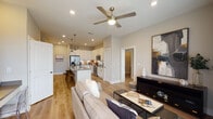 Located at 3612 Beverly Cove Way in Wilmington, NC, this single-floor residence offers a thoughtfully designed open-concept layout that seamlessly connects the main living areas. Light-toned hardwood flooring flows throughout, creating a cohesive and inviting atmosphere.

The kitchen is a standout feature, equipped with white shaker-style cabinetry extending to the ceiling, gray quartz countertops, a white subway tile backsplash, and a full suite of stainless steel appliances. A central island with seating provides both additional prep space and a casual dining option, while pendant lighting adds a refined touch overhead.

The living area is bright and open, benefiting from large windows and sliding glass doors that allow natural light to fill the space and provide outdoor access. A ceiling fan adds comfort and functionality.

The bedrooms are generously sized, each offering ample natural light through large windows. The primary bedroom connects to a spacious en-suite bathroom featuring white cabinetry, gray countertops, and a wide vanity mirror. A second full bathroom mirrors this clean, modern aesthetic with similar finishes.

Neutral wall tones and recessed lighting throughout contribute to the home's airy, contemporary feel, making it a comfortable and well-balanced living space.