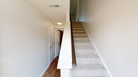 Located at 19 McKinley Dr in McKees Rocks, PA, this three-story townhome offers 3 bedrooms and 3 bathrooms across three well-organized floors. The entry level includes a garage and utility space, providing convenient storage and parking. The main living floor features an open-concept layout where the living room flows seamlessly into the kitchen. The kitchen is equipped with stainless steel appliances, white cabinetry, wood-look flooring, and a pass-through counter that connects to the living area. The upper floor hosts the bedrooms, including a spacious primary bedroom with plush carpeting and a closet. Additional bedrooms are bright and airy, with natural light filtering through well-placed windows offering views of the surrounding greenery. Three full bathrooms serve the home, including one with a walk-in shower. Throughout the home, neutral tones and clean finishes create a bright, welcoming atmosphere. Exterior features include a private driveway, manicured lawn, and neatly trimmed landscaping. The home is situated in a well-kept neighborhood with tree-lined streets and open green spaces.
