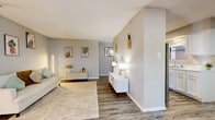 Located at 11955 Parliament St in San Antonio, Texas, this thoughtfully designed 1-bedroom, 2-bathroom residence offers a comfortable and cohesive living experience across a single floor. The living room provides an open, welcoming atmosphere with wood-style plank flooring, soft neutral walls, and ample space for relaxing or entertaining. Adjacent to the living area, the dedicated dining space features a window that brings in natural light, creating a bright and pleasant setting for meals. The galley-style kitchen is well-equipped with white cabinetry, stone-look countertops, a stainless steel sink, and stainless steel appliances, including a full-size refrigerator and range. The spacious primary bedroom offers multiple windows that fill the room with natural light, a generous closet, and a calm, neutral palette. Both bathrooms are finished in clean white tones — one featuring a full tub-shower combo and the other a dual-sink vanity with a large mirror and wood-style flooring. A hallway connects the private areas of the home seamlessly. Throughout the residence, consistent wood-style flooring, textured ceilings, and a soft, modern color scheme create a cohesive and inviting ambiance.