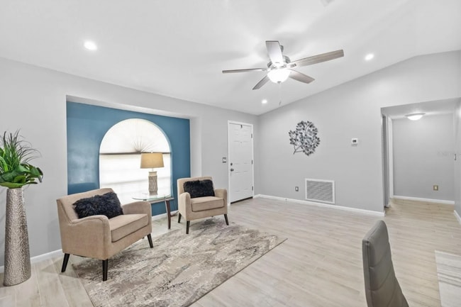Bright, airy living room with vaulted ceilings and plenty of natural light. - 1932 Brainerd Ct