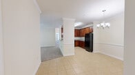 Located at 163 Winter Forest Drive in Candler, NC, this single-story, 4-bedroom, 2-bathroom home offers a well-designed layout across a comfortable footprint. The open-concept kitchen flows seamlessly into the dining and living areas, creating a connected and functional common space. The kitchen is equipped with rich cherry wood cabinetry, granite-look countertops, black appliances including a refrigerator, range, and microwave, and light tile flooring that extends into the dining area. Crown molding and chair-rail detailing add a refined touch throughout the main living spaces. The living room features plush carpet, a ceiling fan, and easy access to the rest of the home. The dining area is accented by a stylish chandelier and louvered double doors that lead to the dedicated laundry room, which includes washer/dryer hookups and tile flooring. The four bedrooms are carpeted and filled with natural light, with the generously sized primary bedroom offering a walk-in closet with wire shelving. The bathrooms are finished with tile flooring, warm wood vanities, granite countertops, and a tub-shower combination. Two closets provide additional storage throughout the home.