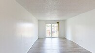 Located at 4236 Armeda Ave in Fort Myers, Florida, this single-floor, 2-bedroom, 2-bathroom residence offers a practical and well-organized layout. Light-toned wood-look flooring flows throughout the living areas and bedrooms, creating a cohesive and clean aesthetic. The living room is a welcoming, open space anchored by a sliding glass door that fills the room with natural light and provides outdoor views, including a peek at a community playground area.

The kitchen features warm-toned wooden cabinetry, grey laminate countertops, a double-basin stainless steel sink beneath a window, and black appliances including an electric range — offering a functional workspace. Textured ceilings are present throughout, adding a classic residential character.

Both bedrooms are bright and well-proportioned, each featuring windows that let in ample natural light and views of the surrounding greenery. The primary bedroom includes a closet with sliding doors. The two bathrooms are clean and efficient — one features a full tub-shower combination with white square tile surround and chrome fixtures, while the other includes a granite-topped vanity with a wood cabinet base and a large mirror. A hallway connects the private areas of the home, completing its straightforward and livable floor plan.