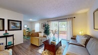Located at 5743 Kingfish Dr in Lutz, Florida, this single-story home offers a well-organized layout designed for comfortable everyday living. The living room serves as the heart of the home, featuring wood-look flooring, a textured ceiling, and a sliding glass door that opens to an outdoor patio overlooking lush greenery — filling the space with natural light and outdoor views. The dining area sits adjacent to the living room and includes a window with sheer curtains, providing a bright and welcoming atmosphere for meals.

The kitchen is equipped with warm oak cabinetry, granite-style countertops, a double basin sink, and a dishwasher, offering ample storage and workspace. The bedrooms are carpeted and feature natural light through sheer-curtained windows; the primary bedroom includes a sliding closet, while the secondary bedroom provides a cozy retreat with neutral tones. The bathroom includes a tub-shower combination, a vanity with white cabinetry, and wood-look flooring. Throughout, the home maintains a cohesive, casual coastal aesthetic with a warm, inviting ambiance.