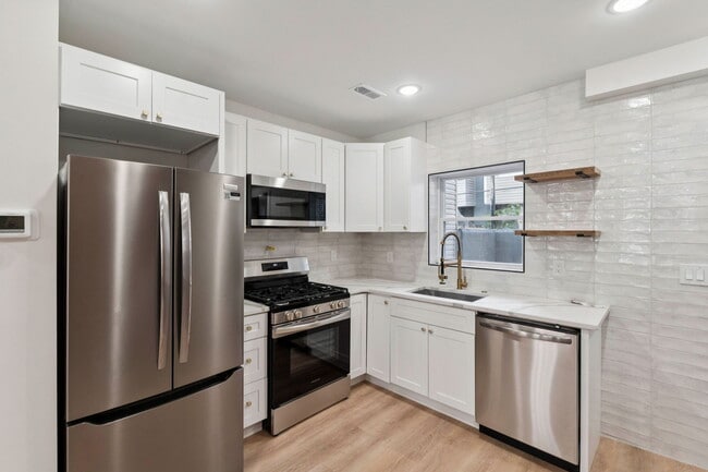 Kitchen with stone countertop and stainless steel appliances - 1544 S Bambrey St