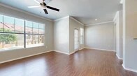 Located in Benbrook, TX, this single-story, two-bedroom, two-bathroom unit offers a thoughtfully arranged floor plan that maximizes its compact footprint. The living room serves as the heart of the space, featuring warm wood-look flooring, crown molding, and a ceiling fan overhead. Large windows dressed with blinds invite generous natural light and provide views of the surrounding neighborhood, creating a bright and welcoming atmosphere.

The kitchen is efficiently designed with oak cabinetry, granite-look countertops, a stainless steel sink, and black appliances including a range and built-in microwave. A galley-style layout ensures practical workflow and ample cabinet storage.

The spacious primary bedroom features plush carpeting, a ceiling fan, a window for natural light, and access to a walk-in closet equipped with wire shelving and hanging rods. The second bedroom also offers carpeted flooring and neutral walls. Both bathrooms include wood-look flooring, with one bathroom featuring a tiled tub-shower combination accented by a classic black-and-white tile border and warm wood cabinetry overhead. Neutral tones and clean finishes throughout give the space a cohesive, move-in-ready appeal.