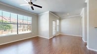 Located in Benbrook, TX, this single-story, two-bedroom, two-bathroom unit offers a thoughtfully arranged floor plan that maximizes its compact footprint. The living room serves as the heart of the space, featuring warm wood-look flooring, crown molding, and a ceiling fan overhead. Large windows dressed with blinds invite generous natural light and provide views of the surrounding neighborhood, creating a bright and welcoming atmosphere.

The kitchen is efficiently designed with oak cabinetry, granite-look countertops, a stainless steel sink, and black appliances including a range and built-in microwave. A galley-style layout ensures practical workflow and ample cabinet storage.

The spacious primary bedroom features plush carpeting, a ceiling fan, a window for natural light, and access to a walk-in closet equipped with wire shelving and hanging rods. The second bedroom also offers carpeted flooring and neutral walls. Both bathrooms include wood-look flooring, with one bathroom featuring a tiled tub-shower combination accented by a classic black-and-white tile border and warm wood cabinetry overhead. Neutral tones and clean finishes throughout give the space a cohesive, move-in-ready appeal.