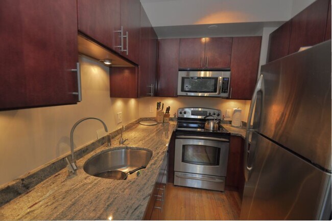 Kitchen features stainless steel appliances, gorgeous granite countertops and generous storage space - 1615 Kenyon Street Northwest
