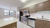 This 570 square foot apartment, located in AMLI Dadeland, Miami, offers a contemporary living space designed for comfort and functionality. The open-concept layout maximizes the use of space, seamlessly connecting the kitchen, living room, and dining area. The kitchen is a standout feature, boasting sleek wood-grain cabinetry, stainless steel appliances, and a convenient kitchen island, perfect for meal preparation or casual dining. Large windows in the living area flood the space with natural light, while also offering views of the surrounding area. The bathroom is well-appointed with modern fixtures and a combination tub-shower. Throughout the apartment, neutral tones and clean lines create a fresh, inviting atmosphere. The use of durable materials like tile flooring in the kitchen and bathroom, and wood-look flooring in the living areas, ensures both style and practicality. This apartment represents an ideal blend of urban living and home comfort in the heart of Miami.