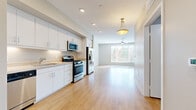 Located at 3411 Grande Vista Pkwy in Riverside, CA, this single-floor unit offers a clean, modern layout that makes excellent use of its compact footprint. Light wood-style flooring runs throughout the entire space, creating a cohesive and warm aesthetic that ties each area together seamlessly.

The open-concept design connects the kitchen directly to the living room, maximizing the sense of space and encouraging easy flow between the two areas. The kitchen is well-appointed with white cabinetry extending to the ceiling for generous storage, light countertops, a built-in sink, and a full suite of stainless steel appliances including a gas range, over-the-range microwave, dishwasher, and refrigerator. Recessed lighting and under-cabinet illumination keep the kitchen bright and functional.

The living room is bathed in natural light from a large window fitted with horizontal blinds, offering a view of the surrounding greenery. A ceiling fan with an integrated light fixture provides both comfort and additional illumination. The neutral gray walls and clean lines give the space a calm, versatile atmosphere.

The bathroom features a tub/shower combo with white tile surround, a single vanity with a mirror, and wood-style flooring consistent with the rest of the unit. A dedicated closet provides practical storage, completing this thoughtfully designed space.