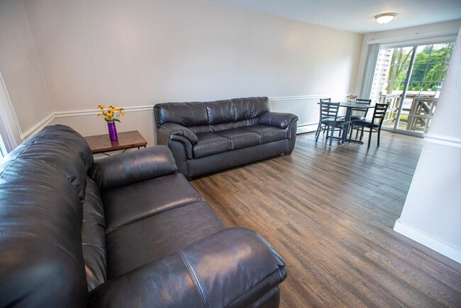 Living room with 2 leather couches - The URI Townhouses