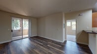 Located at 3450 El Camino Real in Santa Clara, California, this single-floor residence offers a well-designed layout with a warm, neutral color palette throughout. The open living area is finished with rich, dark hardwood-style flooring and features sliding glass doors that lead to a private balcony, filling the space with natural light and offering pleasant outdoor views. An arched hallway connects the living area to the rest of the unit, adding an architectural touch to the interior.

The kitchen is thoughtfully designed with warm wood cabinetry, dark granite countertops, and stainless steel appliances including a refrigerator, range, microwave, and dishwasher. Wood-look flooring and recessed lighting complete the kitchen's polished, functional aesthetic. A peninsula-style counter variant is also present in select units, providing additional prep and dining space.

The bedrooms are carpeted for comfort and receive generous natural light through large windows overlooking lush greenery. Built-in shelving in one bedroom adds practical storage. Baseboard heating is present throughout.

The bathrooms are clean and bright, featuring sliding glass-enclosed shower and tub combinations with white tile surrounds, wood-look flooring, and built-in shelving for added convenience. The overall ambiance of the space is bright, clean, and move-in ready.