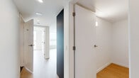 Located in Vancouver's vibrant West End neighbourhood, this modern 2-bedroom, 1-bathroom unit at 1655 Davie Street offers a well-designed layout with contemporary finishes throughout. Light wood laminate flooring flows consistently across the living areas and bedrooms, creating a warm and cohesive aesthetic.

The kitchen is a standout feature, outfitted with dark matte cabinetry, white countertops, a clean tile backsplash, and stainless steel appliances including a range, over-the-range microwave, and refrigerator. Track lighting above adds functional brightness to the space.

The primary bedroom is generously proportioned and includes a built-in closet with open shelving, while clean white walls and light flooring keep the room feeling bright and airy. The second bedroom offers flexible utility as an additional sleeping space or home office.

The bathroom is finished in a modern style, featuring large-format charcoal floor tiles, a wall-mounted vessel sink atop a dark countertop with white cabinetry, and a mirrored medicine cabinet above.

The hallways are clean and efficiently designed, with a bold dark accent wall adding a touch of visual contrast. Recessed lighting throughout maintains a bright, contemporary ambiance. The unit also includes a dedicated storage room with a utility access panel.