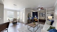 Located at 4600 Bellaire Drive South in Fort Worth, TX, this one-bedroom, one-bathroom residence offers a well-organized layout across a single floor. The welcoming entrance opens into a hallway adorned with wood-style flooring that flows throughout the main living areas. The combined living and dining room is a highlight of the unit, featuring crown molding, decorative columns, a ceiling fan, and built-in shelving. Large windows in the dining area flood the space with natural light and offer views of the surrounding greenery, creating a bright and airy atmosphere. The kitchen is equipped with rich dark cabinetry, granite-style countertops, a classic subway tile backsplash, and stainless steel appliances, providing both style and functionality. The spacious primary bedroom is finished with plush carpet and crown molding, offering a comfortable retreat. The bathroom features dark wood vanity cabinetry, a granite-topped sink, a Hollywood-style light bar, and a tub-shower combination. Additional conveniences include a dedicated laundry area, three closets for ample storage, and a private entrance. The cohesive neutral palette and quality finishes throughout lend the space a polished and inviting character.