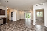 Located at 5719 NW 57th Ave in Johnston, Iowa, this single-floor, 3-bedroom, 2-bathroom home offers a well-designed layout with modern finishes throughout. The open-concept living area is bright and spacious, featuring wood-look luxury vinyl plank flooring, recessed lighting, and neutral toned walls that create a clean, contemporary feel. A large sliding glass door floods the living room with natural light while providing direct views of the surrounding greenery outdoors.

The kitchen is outfitted with dark espresso cabinetry, granite countertops, and stainless steel appliances, including a dishwasher and refrigerator. It opens seamlessly into the main living area, making the space functional and social.

All three bedrooms are carpeted and offer a quiet, comfortable retreat. The primary bedroom is a well-proportioned space that connects to a private bathroom, which features dark wood vanity cabinetry with granite countertops and wood-look LVP flooring. A dedicated closet adds practical storage. The second full bathroom mirrors the same design aesthetic, complete with a full tub and shower combination.

Additional highlights include a hallway connecting the bedroom wing, a dedicated closet for storage, and consistent neutral finishes that lend a cohesive, move-in-ready quality to the entire home.