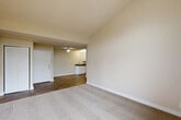 Located at 655 Enterprise Dr in Rohnert Park, CA, this well-appointed 2-bedroom, 2-bathroom single-floor residence offers a thoughtfully designed layout across a comfortable footprint. The open-concept kitchen and dining area is equipped with stainless steel appliances—including a gas range, dishwasher, and refrigerator—complemented by crisp white shaker cabinetry, dark countertops, and durable hardwood-style flooring that extends through the main living areas. The living room features plush carpeting, a vaulted ceiling accent, and a sliding glass door that opens to a private balcony, allowing for natural light and outdoor views. Both bedrooms are carpeted and well-lit, with the secondary bedroom benefiting from dual windows that bring in ample natural light. Each bedroom includes closet storage, with one featuring a spacious walk-in style closet with a hanging rod. The two bathrooms are clean and functional—one with a dedicated walk-in shower with a glass door, and the other with a full tub-shower combination, both finished with wood-look flooring and white cabinetry with dark countertops. Additional conveniences include dedicated laundry and utility areas, two hallways for smooth circulation, and a ceiling fan in the kitchen-dining space.