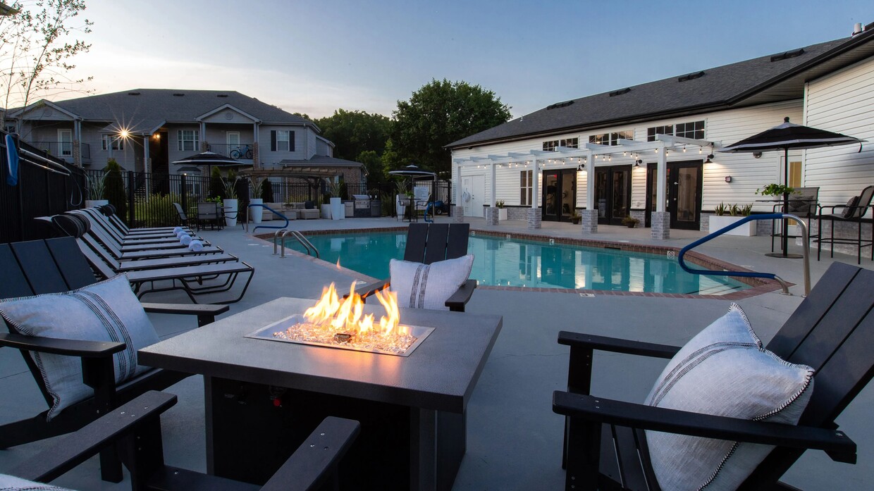 Enjoy the enchanting glow of our community fire pit, creating the perfect atmosphere for evening relaxation under the starry night sky. - Greystone Woods