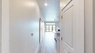 Located at 112 W Papermill Run in Kimberly, WI, this well-appointed 2-bedroom, 2-bathroom single-story home offers a thoughtfully designed open-concept layout with a clean, modern aesthetic throughout. Light-toned luxury vinyl plank flooring flows continuously across the living spaces, complemented by neutral wall tones and crisp white trim.

The combined kitchen and living room serves as the heart of the home, anchored by a large granite-topped island and outfitted with sleek, high-gloss white cabinetry, stainless steel appliances, and a dedicated pantry. A wide sliding glass door and adjacent windows flood the living area with natural light and provide outdoor views, while a ceiling fan adds comfort. A fireplace adds a focal point to the shared living space.

Both bedrooms feature high ceilings, recessed lighting, and generous proportions. The primary bedroom offers access to a spacious walk-in closet equipped with wire shelving systems. A second closet mirrors this practical storage design. Both bathrooms are finished with granite-topped vanities and wood-toned cabinetry, and the full bath includes a tub-shower combo with a curved curtain rod.

A dedicated laundry room houses a full-size front-loading washer and dryer with additional wire shelving overhead. The home's layout is completed by a well-proportioned hallway connecting all rooms efficiently.