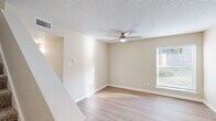 Located in the Birchtree community of Memphis, TN, this two-story home offers three bedrooms and three bathrooms thoughtfully distributed across two well-proportioned floors. The main level features a welcoming living room with light hardwood-style flooring, a ceiling fan, and natural light streaming through slatted blinds. The kitchen is equipped with stainless steel appliances, including a full-size refrigerator and dishwasher, complemented by light cabinetry and stone-look countertops. A half bath and hallways connecting key areas round out the first floor. Upstairs, the bedrooms provide comfortable retreats with a mix of hardwood-style and plush carpeted flooring. The generously sized primary bedroom includes its own bathroom, offering added privacy. Additional bedrooms are bright and airy, each with windows that invite natural light. The upper-level bathrooms feature clean white tub-shower combinations with built-in shelving. Throughout the home, neutral warm-beige walls, textured ceilings, and consistent trim work create a cohesive and inviting atmosphere. Two closets provide practical storage, and a staircase connects the two floors seamlessly. This home delivers a functional and comfortable layout suited for everyday living.
