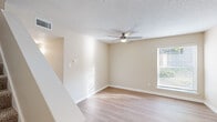 Located in the Birchtree community of Memphis, TN, this two-story home offers three bedrooms and three bathrooms thoughtfully distributed across two well-proportioned floors. The main level features a welcoming living room with light hardwood-style flooring, a ceiling fan, and natural light streaming through slatted blinds. The kitchen is equipped with stainless steel appliances, including a full-size refrigerator and dishwasher, complemented by light cabinetry and stone-look countertops. A half bath and hallways connecting key areas round out the first floor. Upstairs, the bedrooms provide comfortable retreats with a mix of hardwood-style and plush carpeted flooring. The generously sized primary bedroom includes its own bathroom, offering added privacy. Additional bedrooms are bright and airy, each with windows that invite natural light. The upper-level bathrooms feature clean white tub-shower combinations with built-in shelving. Throughout the home, neutral warm-beige walls, textured ceilings, and consistent trim work create a cohesive and inviting atmosphere. Two closets provide practical storage, and a staircase connects the two floors seamlessly. This home delivers a functional and comfortable layout suited for everyday living.