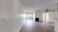 Located at 8541 Foothill Blvd in the Sunland-Tujunga neighborhood of Los Angeles, this single-floor, 3-bedroom, 2-bathroom home offers a well-organized and functional layout. The spacious living room features light wood-style flooring, a fireplace, a textured ceiling, and a large sliding glass door that fills the space with natural light and provides access to an outdoor area. Adjacent to the living room, the open kitchen is equipped with gray cabinetry, a stainless steel gas range, a dishwasher, and a pass-through counter that connects seamlessly to the dining area. The three bedrooms are carpeted and well-lit, with windows offering views of the surrounding mountains and greenery. Each bedroom includes closet space, and the primary bedroom is generously sized. The two bathrooms feature rich dark wood vanities with light countertops, wood-style flooring, and tub-shower combinations. A hallway connects the bedrooms and bathrooms, providing an efficient flow throughout the home. Throughout the space, a neutral color palette, consistent flooring materials, and ample natural light contribute to a clean, bright, and welcoming ambiance.
