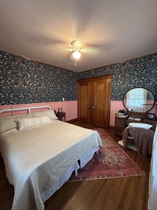 A Queen size bed is located in Bedroom #2 on the main floor of the home, opposite of Bedroom #1. - 186 Linwood St