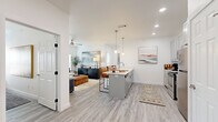 Located at 1506 Powell St in Springdale, Arkansas, this well-appointed one-bedroom, one-bathroom unit offers a thoughtfully designed layout across a single floor. Light wood-style flooring flows seamlessly throughout, creating a cohesive and airy aesthetic. The open-concept kitchen and living area serves as the heart of the home, featuring gray shaker cabinets, white quartz countertops, stainless steel appliances, a central island with pendant lighting, and direct sightlines into the spacious living room. The living room is bathed in natural light through large windows with blinds, and includes a ceiling fan for added comfort. A dedicated office provides a private workspace complete with a closet and ceiling fan, ideal for remote work or study. The bedroom is a calm retreat with multiple windows, a ceiling fan, and generous proportions. The full bathroom is finished with a gray shaker vanity, white quartz countertop, a large mirror, gold-toned light fixtures, and wood-style flooring. In-unit laundry is also included, adding everyday convenience. Clean white walls and recessed lighting throughout contribute to the bright, modern ambiance of this well-designed Springdale residence.