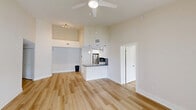 Located in Plantation, FL, this single-floor, 4-bedroom, 2-bathroom home offers a clean, modern aesthetic with light wood-style flooring carried consistently throughout. The open-concept living room and kitchen area is anchored by soaring ceilings and a well-appointed kitchen featuring white shaker cabinetry, dark granite countertops, a matching backsplash, stainless steel appliances, and stylish pendant lighting over a breakfast bar peninsula. Sliding glass doors in the living area and primary bedroom open to outdoor views, filling the space with abundant natural light. The four bedrooms are bright and airy, each equipped with ceiling fans and windows fitted with horizontal blinds. The primary bedroom offers generous proportions with direct outdoor access. Both bathrooms are finished with light, neutral tones; one features a full tub-shower combo, while the other includes a wide vanity with dark granite countertops, a large mirror, and modern fixtures—both with wood-style flooring. A hallway and closet provide additional storage and connectivity throughout. The overall ambiance is fresh, neutral, and move-in ready, suited for comfortable everyday living.