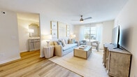 Located at 412 Chardonnay Cir in Brandon, Mississippi, this single-story, 3-bedroom, 2-bathroom home offers a thoughtfully designed layout across a compact yet efficiently utilized footprint. The interior is unified by a soft, neutral color palette and wood-look plank flooring that runs throughout the main living areas, creating a cohesive and airy aesthetic.

The living room serves as the heart of the home, featuring a ceiling fan, natural light from a front-facing window, and open sightlines that connect to the hallway and surrounding rooms. An entryway area is accented by a decorative console and a gold-framed mirror, adding a refined touch upon entry.

The kitchen is well-equipped with shaker-style cabinetry in a light gray-white finish, white quartz countertops, a subway tile backsplash, and stainless steel appliances including a refrigerator and dishwasher. Adjacent dining space provides a functional area for everyday meals.

The primary bedroom offers carpeted flooring, a ceiling fan, and natural light from a window with sheer draping. The bathrooms feature white vanities with quartz countertops, illuminated mirrors, and a tub-shower combination with wood-look tile flooring. A dedicated laundry room houses a full-size washer and dryer, completing this practical and polished home.