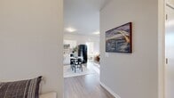 This contemporary 890 square foot apartment in Bettendorf, Iowa, offers a thoughtfully designed single-story layout with two bedrooms and two bathrooms. The open-concept living area creates a spacious feel, seamlessly connecting the living room, dining area, and kitchen. The living room features large windows that flood the space with natural light, complemented by a ceiling fan for comfort.

The kitchen boasts crisp white cabinetry, contrasting black appliances, and ample counter space, making it both functional and aesthetically pleasing. A small dining area adjacent to the kitchen provides a cozy spot for meals.

The primary bedroom, measuring 150 square feet, offers a serene retreat with plush carpeting and large windows. Both bathrooms feature modern fixtures, including tub-shower combinations and stylish vanities. The second bedroom doubles as a versatile space, ideal for a guest room or home office.

Throughout the apartment, neutral tones and wood-look flooring create a cohesive, contemporary ambiance. Tasteful artwork and decor accents add personality to each room. The property's thoughtful design maximizes the use of space, offering residents a comfortable and stylish living environment in a prime Bettendorf location.