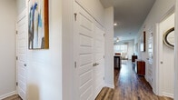Located at 702 US-80 in Bloomingdale, Georgia, this single-floor residence offers two bedrooms and two bathrooms within a thoughtfully designed layout. Hardwood-style flooring flows throughout the main living areas, creating a cohesive and polished aesthetic.

The kitchen is equipped with rich dark cabinetry, granite countertops, stainless steel appliances — including a refrigerator, range, and built-in microwave — and a peninsula with bar seating accented by pendant lighting. It opens naturally toward the living area, which features a ceiling fan, large windows with blinds and sheer curtains, and ample natural light.

The primary bedroom is a well-proportioned retreat with carpet flooring, a large window, and generous wall space. The second bedroom mirrors this comfortable design with its own window and soft carpeting. Both bathrooms continue the granite and dark cabinetry theme seen in the kitchen, with one bathroom featuring a shower-tub combination.

A hallway with panel doors provides access to the bedrooms and bathrooms, maintaining a clean and organized flow throughout the unit. The overall ambiance is bright, modern, and welcoming — a practical yet stylish residence in the Bloomingdale community.