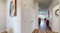 Located at 702 US-80 in Bloomingdale, Georgia, this single-floor residence offers two bedrooms and two bathrooms within a thoughtfully designed layout. Hardwood-style flooring flows throughout the main living areas, creating a cohesive and polished aesthetic.

The kitchen is equipped with rich dark cabinetry, granite countertops, stainless steel appliances — including a refrigerator, range, and built-in microwave — and a peninsula with bar seating accented by pendant lighting. It opens naturally toward the living area, which features a ceiling fan, large windows with blinds and sheer curtains, and ample natural light.

The primary bedroom is a well-proportioned retreat with carpet flooring, a large window, and generous wall space. The second bedroom mirrors this comfortable design with its own window and soft carpeting. Both bathrooms continue the granite and dark cabinetry theme seen in the kitchen, with one bathroom featuring a shower-tub combination.

A hallway with panel doors provides access to the bedrooms and bathrooms, maintaining a clean and organized flow throughout the unit. The overall ambiance is bright, modern, and welcoming — a practical yet stylish residence in the Bloomingdale community.