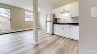Located at 800 Exmouth St in Sarnia, Ontario, this 2-bedroom unit offers a practical and well-appointed layout across a single floor. Throughout the space, light-toned hardwood-style flooring creates a clean, cohesive aesthetic that ties each room together seamlessly.

The open living room is a highlight of the unit, featuring large sliding glass doors that flood the space with natural light and provide views of the surrounding neighbourhood. A second window further enhances the bright, airy atmosphere. Baseboard heating runs along the walls, ensuring comfortable warmth throughout the seasons.

Adjacent to the living room, the kitchen is outfitted with crisp white cabinetry, dark countertops with a subway tile backsplash, a stainless steel refrigerator, and a built-in sink — offering both style and functionality in a compact, efficient layout.

The primary bedroom is a well-sized, quiet retreat featuring a large window with natural views and a full-height sliding closet with clean white panel doors, providing ample storage. The second bedroom mirrors the unit's consistent style with its own window and baseboard heating.

Neutral warm-beige walls throughout the unit complement the flooring and contribute to a calm, welcoming ambiance. The overall design is clean, modern, and move-in ready, making this an ideal space for those seeking comfortable urban living in Sarnia.