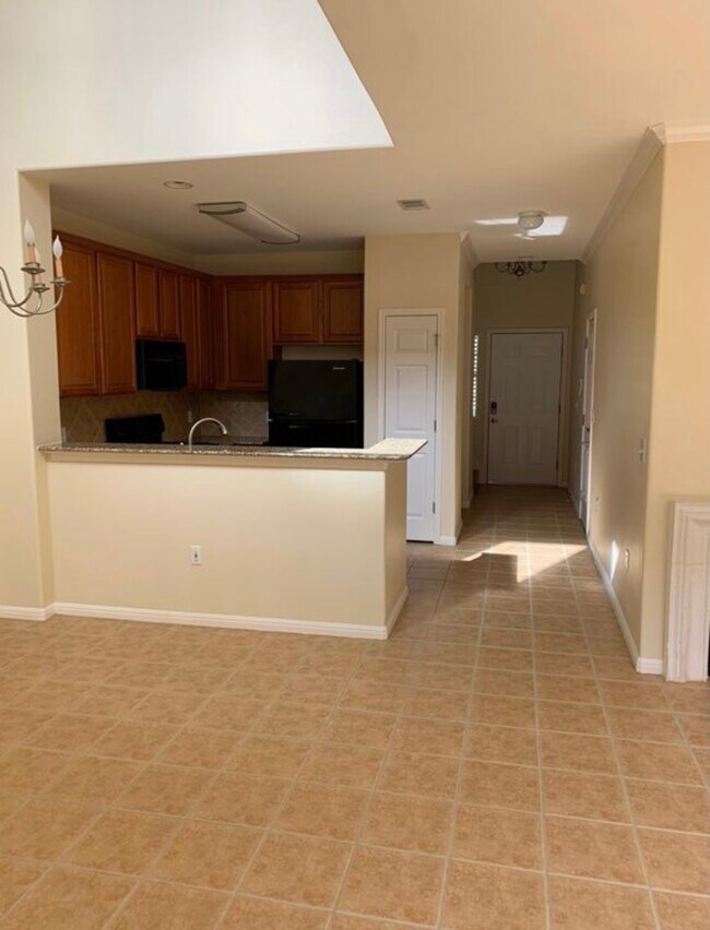 View of dining room, kitchen, front door. Powder room, closet, garage door in this hallway. - 7708 San Felipe Blvd