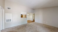 Located at 5915 Flintlock Rd in Houston, TX, this 2-bedroom, 1-bathroom apartment offers a well-organized single-level layout with a comfortable and functional design throughout. The living room serves as the heart of the home, featuring plush carpeting, a tile-surround wood-burning fireplace, and a sliding glass door that opens to a private balcony with outdoor views. A pass-through window connects the living area to the galley-style kitchen, which is outfitted with white cabinetry, laminate countertops, tile backsplash, wood-look flooring, and black appliances including a refrigerator, electric range, and dishwasher. An adjacent dining area with a chandelier adds an elegant touch. The spacious primary bedroom features carpet flooring, a ceiling fan with light fixture, and natural light from a window. It connects directly to the bathroom vanity area, which includes dual mirrors and generous cabinet storage, along with access to a walk-in closet. The second bedroom is equally well-appointed with carpet, a ceiling fan, and a window. The full bathroom features a tiled shower-tub combination and wood-look flooring. A dedicated carpeted closet provides additional storage, completing this practical and comfortable Houston residence.