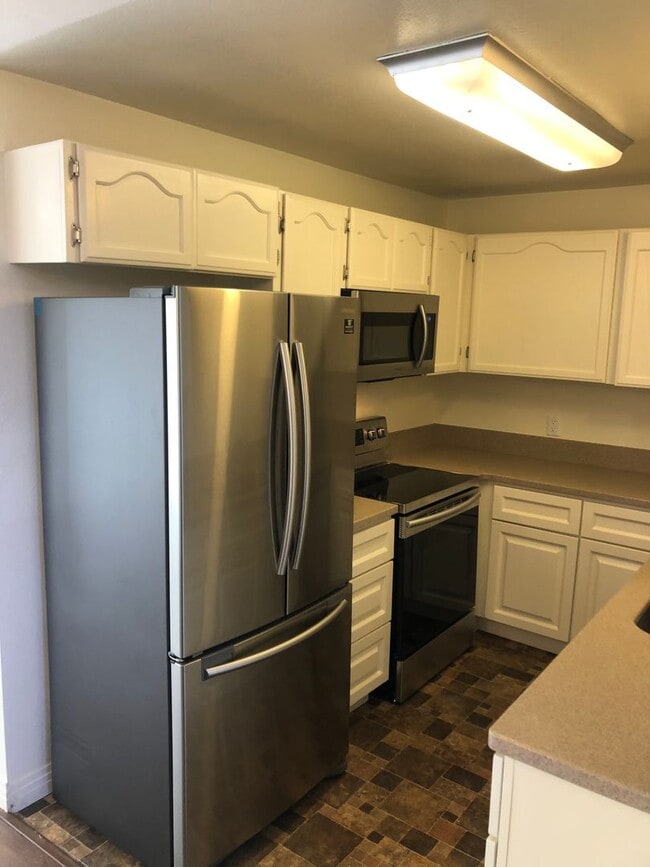 Building Photo - Beautiful Townhome with large fenced back patio, second story balcony, and two covered parking spots