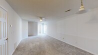 Located at 4305 W Washington St in Springfield, Illinois, this single-floor residence offers a clean, functional layout designed for comfortable everyday living. The spacious living area features neutral-toned wall-to-wall carpeting, a ceiling fan with integrated lighting, and a textured ceiling. Large sliding glass doors allow natural light to fill the room, creating a bright and open atmosphere. An adjoining area with a pendant light provides additional flexible living or dining space.

The kitchen is equipped with warm-toned wooden cabinetry, a decorative tile backsplash, laminate wood-style flooring, and includes appliances such as a refrigerator, dishwasher, and a double-basin sink, offering a practical and organized cooking environment.

The bedrooms are carpeted and feature large closets with six-panel bi-fold doors, providing ample storage. Windows in the bedrooms frame views of the surrounding greenery, bringing in natural light and a connection to the outdoors.

The bathroom is well-appointed with a combination tub and shower, a single-sink vanity with wooden cabinetry, a mirrored medicine cabinet with overhead lighting, and wood-style flooring, completing this straightforward and well-maintained residence.