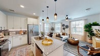 Located in Manor, TX, this well-appointed single-story home offers a smart and functional layout across a comfortable footprint. The open-concept kitchen and living area serves as the heart of the home, where a granite-topped island with a stainless steel sink anchors the kitchen. White shaker cabinetry, a subway tile backsplash, stainless steel appliances, and stylish pendant lighting add a modern yet warm character to the space. The kitchen flows naturally into the dining and living areas, which are bathed in natural light from multiple large windows and finished with light wood-style flooring. A ceiling fan completes the living room, which offers a bright, airy ambiance. A dedicated office provides a quiet, carpeted retreat ideal for focused work. The generously sized primary bedroom features plush carpeting, a ceiling fan, and direct access to a spacious walk-in closet outfitted with multi-level shelving and hanging rods. A second closet near the entry provides additional storage. Both bathrooms are finished with granite countertops, undermount sinks, and clean white cabinetry. Light wood-style flooring continues through the hallways, tying the home together with a cohesive, contemporary aesthetic throughout.