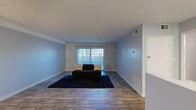 Located at 3830 University Center Drive in Las Vegas, NV, this one-bedroom, one-bathroom unit offers a practical and well-appointed single-floor layout. The living room is generously sized, featuring wood-look flooring, neutral gray walls, and a textured ceiling. A large sliding glass door with vertical blinds fills the space with natural light and provides outdoor access. The galley-style kitchen is efficiently designed with white shaker cabinetry, granite-style countertops, black appliances including a range and dishwasher, a double-basin sink, and a narrow window that brings in additional natural light. The bedroom is a comfortable retreat with plush carpeting, a ceiling fan, vertical blinds, and ample wall space, complemented by a dedicated closet for storage. The bathroom is clean and functional, featuring a vanity with granite-style countertops, wood-look tile flooring, and a full tub-shower combination. Throughout the unit, the consistent use of neutral tones and updated finishes creates a cohesive and move-in-ready atmosphere well-suited for comfortable everyday living in Las Vegas.