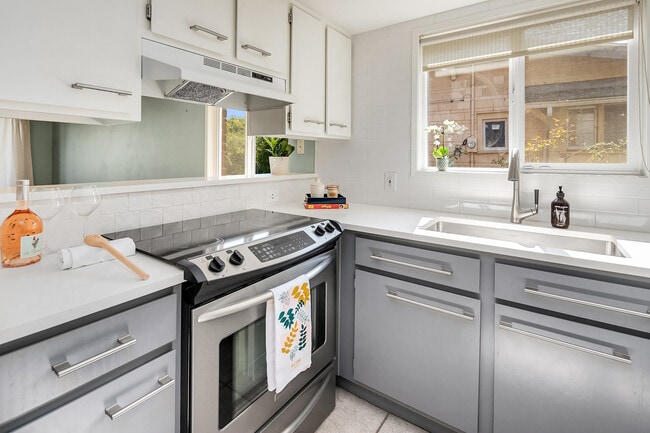 Renovated kitchen with high end appliances(Liebherr/KitchenAid), modern paint, tile backsplash. - 7051 8th Ave NW