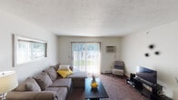 Located at 1941 Lafayette Ave in Lebanon, Indiana, this single-floor residence offers a comfortable and functional layout designed for everyday living. The living room serves as the heart of the home, featuring plush carpeting, a textured ceiling, and a large sliding glass door fitted with vertical blinds that invites abundant natural light and provides direct outdoor access. A wall-mounted air conditioning unit ensures year-round comfort, while a side window adds additional brightness to the space.

The bedrooms are generously proportioned, each with carpeted floors, textured ceilings, and windows dressed with blinds that allow for adjustable natural light. One bedroom features dual closets with bifold doors, offering ample storage, while another includes its own wall-mounted air conditioning unit for personalized climate control.

The kitchen is efficiently arranged with white cabinetry trimmed in warm wood tones, light countertops, and wood-look flooring. It is equipped with a full-size refrigerator, dishwasher, and sink, providing all the essentials for daily meal preparation.

The bathroom features wood-look flooring, a shower-tub combination, a single vanity with under-sink storage, and open shelving for convenient organization. Throughout the residence, the consistent use of neutral tones and practical finishes creates a cohesive, move-in-ready living environment.