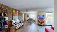 This single-floor residence at 200 Cold Spring Rd in Rocky Hill, Connecticut, offers a thoughtfully arranged layout encompassing two bedrooms, two bathrooms, a living room, dining room, kitchen, and two hallways. A standout architectural feature is the exposed brick accent wall that runs through the living area and into the kitchen, lending the space a warm, industrial character balanced by bright white walls and hardwood-style flooring throughout the main areas.

The open living and dining area flows naturally from one to the other, connected by a charming arched passageway. The living room receives natural light through sliding glass doors, while the dining room benefits from a large window with outdoor views. The kitchen is outfitted with granite-style countertops, white cabinetry, stainless steel appliances, and the same striking brick wall, creating a functional yet visually dynamic cooking space.

The primary bedroom features carpeted flooring and a comfortable, neutral palette, while the second bedroom includes built-in shelving and closet space. Both bathrooms are clean and well-lit, each with vanity storage and mirrored fixtures. Hallways connect the rooms with ease, contributing to the overall practical and cohesive flow of the residence.