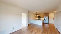 Located at 1619 N Neva Ave, Unit 330 in Chicago, IL, this well-designed 2-bedroom, 2-bathroom unit offers a thoughtfully laid-out single-floor plan with modern finishes throughout. The kitchen is a standout feature, boasting light wood cabinetry with matte black hardware, quartz countertops, a large center island with an undermount sink, stainless steel appliances, and warm hardwood flooring. A stylish pendant light fixture adds a contemporary touch above the island. Both bedrooms are carpeted and bathed in natural light through large windows that offer views of the surrounding neighborhood. The rooms are clean and neutral in palette, providing a bright and versatile canvas. Two dedicated closets offer practical storage solutions. The primary bathroom features a wide vanity with wood cabinetry, quartz countertops, a backlit mirror, and a glass-enclosed shower, all finished with light tile flooring. The secondary bathroom is equally well-appointed with a glass shower enclosure and tile flooring. The unit's clean lines, neutral tones, and modern fixtures create a cohesive and contemporary living environment throughout.