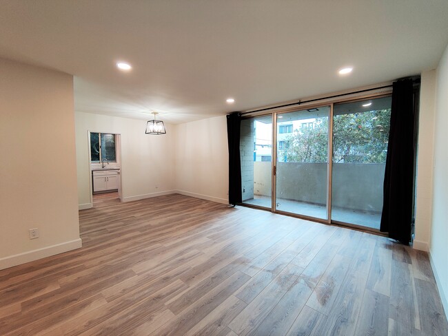 Living Room leading to Dining Area & Private Balcony - 1300 Midvale Ave